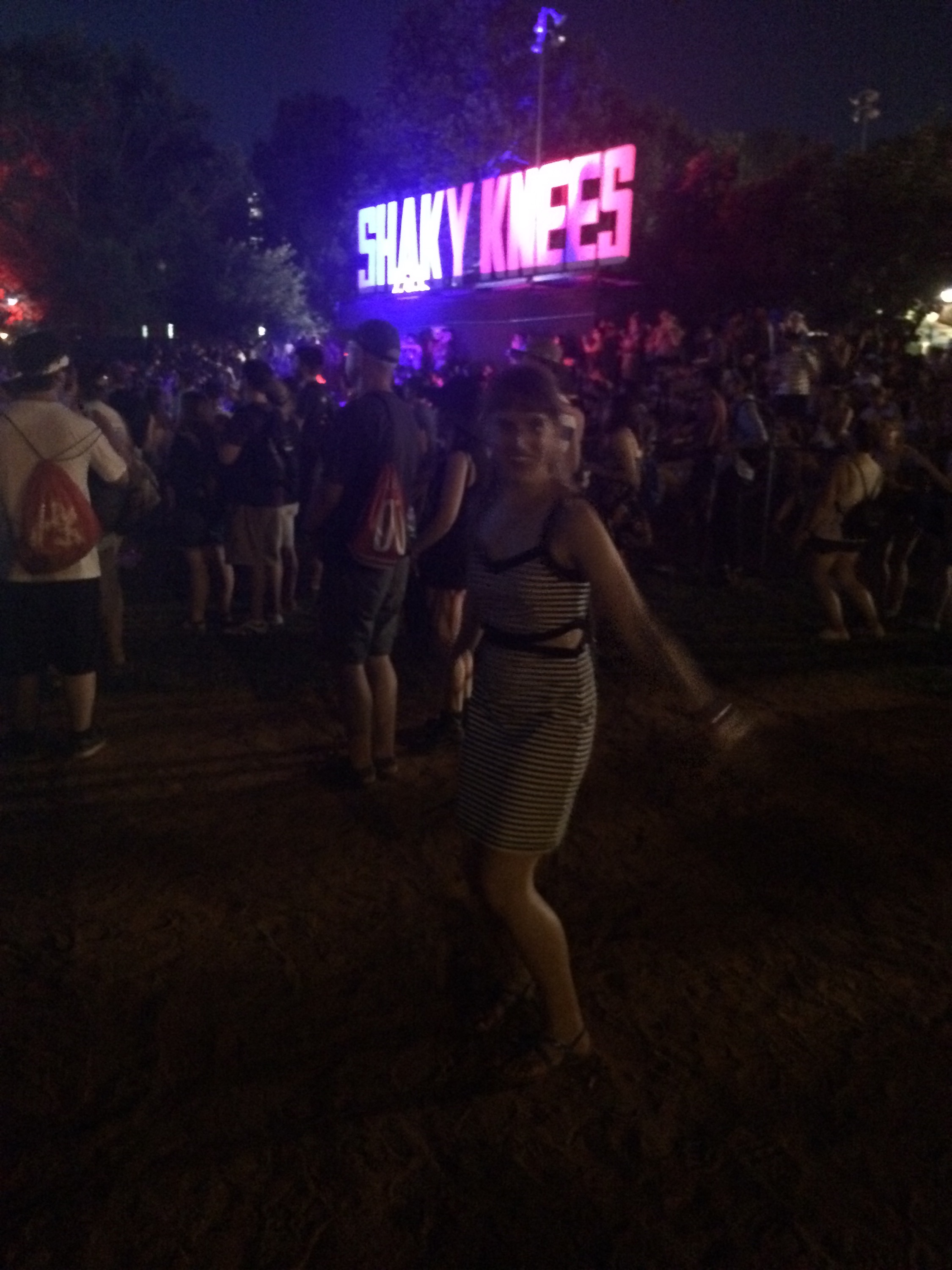 Jumping white girl in front of a sign. 